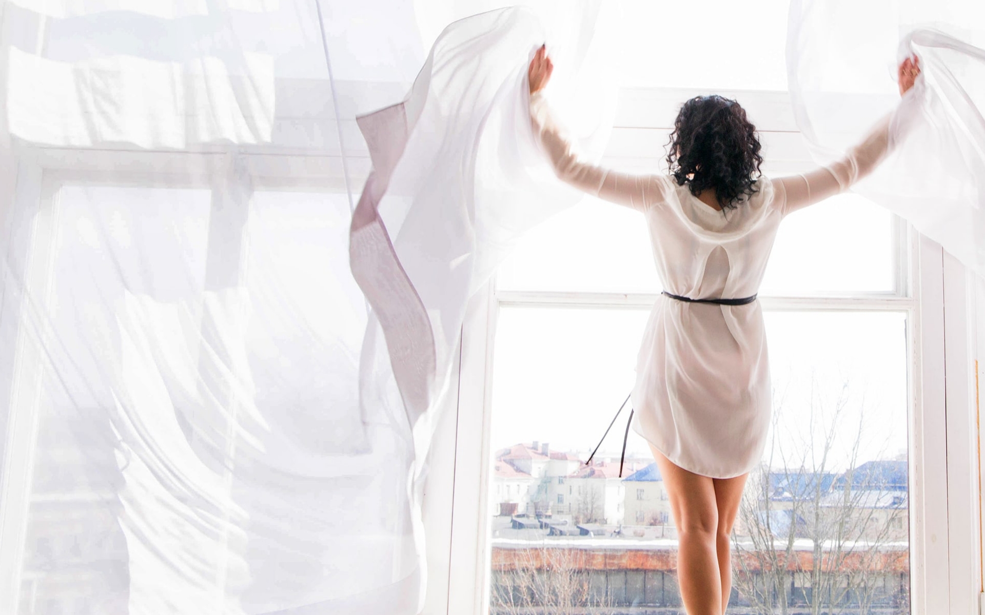 Women enjoying here room and appreciating the hotel view