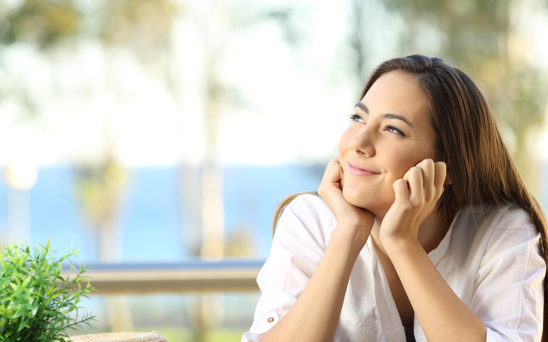 Woman gazing out of hotel window