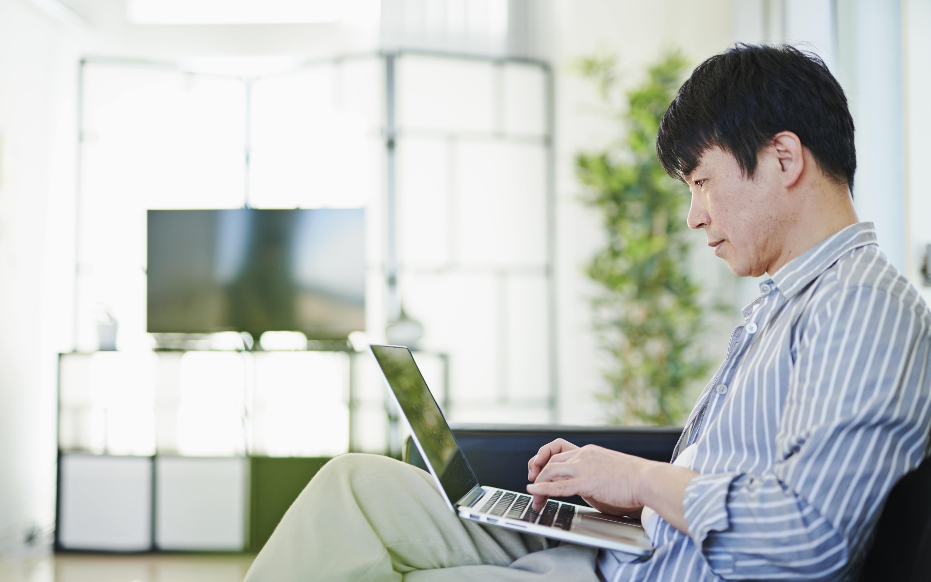 Man using his computer in a hotel room